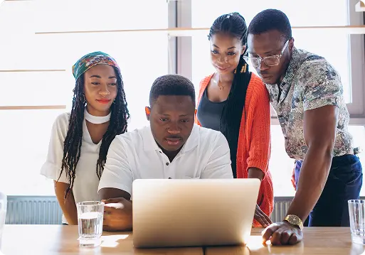 The Legacyinks team collaborating around a laptop